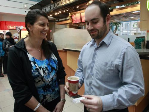 Ryan Fedorowich in Portage Place with his free coffee paid for by Yvette Deveau, a local woman who is surprising Winnipegers with random acts of kindness (paying for their coffee, etc.), then encouraging them to pay it forward by doing something nice for someone else (part of a larger mission called Pay It Forward Manitoba).  ¤¤¤ Sarah Petz story  (WAYNE GLOWACKI/WINNIPEG FREE PRESS) Winnipeg Free Press  Dec.13   2012