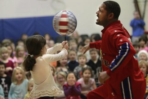 "Handles" Franklin, a member of the Harlem Globetrotters gets a basketball spinning on the tip of a pen held by preschooler Ella,5, during Handles presentation teaching children the ABCs of Bullying Prevention at Voyageur Elementary School Thursday. This is a community outreach program designed by the Harlem Globetrotters in coordination with the National Campaign to Stop Violence, the kids were taught how Action, Bravery and Compassion can be used to reduce and stop bullying. The Globetrotters will playing a game at the  MTS Centre on Thursday, Jan. 5 at 2 p.m.  see release.   (WAYNE GLOWACKI/WINNIPEG FREE PRESS) Winnipeg Free Press  Dec.13   2012