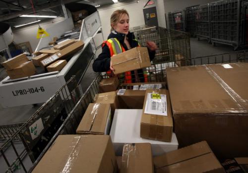 Postie Kelly Dunitz puts another package on a pile bound towards their christmas destinations Thursday evening in Winnipeg's Central Station....It's Canada Post's busiest day of the year. See Martin Cash story.....December 13, 2012 - (Phil Hossack / Winnipeg Free Press)