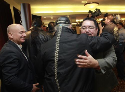 At right, Chief Glenn Hudson is embraced by Bill Traverse the AFN Regional Chief of Manitoba,  at left is lawyer Norman Boudreau after the announcement of the recent federal court decision regarding Kapyong Barracks.  Larry Kusch story    (WAYNE GLOWACKI/WINNIPEG FREE PRESS) Winnipeg Free Press  Dec.14   2012