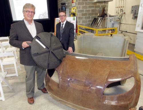 Joe Hogue, manager of FlaxStalk Business Development, left, and Sean McKay, Executive Director Composites Innovation Centre. Hogue holds a farm equipment cap and McKay with a car body made from natural fibers. December 14, 2012  BORIS MINKEVICH / WINNIPEG FREE PRESS