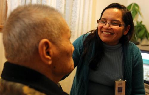 Segundo Ednilao is helped by Ducila Torres, a health care aide with the Winnipeg Regional Health Authority, Friday, December 14, 2012. (TREVOR HAGAN/WINNIPEG FREE PRESS)