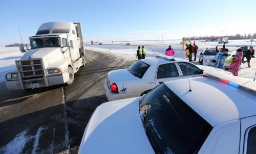 Members of Sandy Bay First Nation use a blockade on the Trans-Canada between Highway 16 and Road 42 West, to protest budget bill C45, Saturday, December 15, 2012. (TREVOR HAGAN/WINNIPEG FREE PRESS)