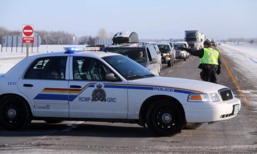 RCMP direct traffic as members of Sandy Bay First Nation use a blockade on the Trans-Canada between Highway 16 and Road 42 West, to protest budget bill C45, Saturday, December 15, 2012. (TREVOR HAGAN/WINNIPEG FREE PRESS)