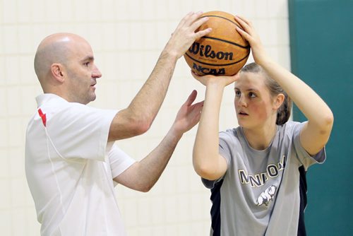Brandon Sun 16122012 NBA Shooting Consultant Dave Love gives Shayna Mathison with the Hamiota Huskies some tips during a basic shooting mechanics clinic for grades 7-12 boys and girls put on by Neelin High School at the school gymnasium on Sunday morning.  (Tim Smith/Brandon Sun)