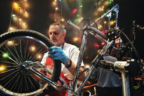 Jason Carter the past president of the Manitoba Cycling Association works on a bike during the Cycle of Giving at the Atomic Centre on Logan Avenue. Dozens of mechanics have been working for the last twenty-four hours fixing up over 200 bicycles for Winnipeg children in need in the second annual event.  121216 December 16, 2012 Mike Deal / Winnipeg Free Press