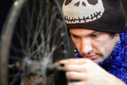 Geoff Heath the mechanical director at The Wrench, a bicycle repair education and cycling hub, works on fixing some spokes during the Cycle of Giving at the Atomic Centre on Logan Avenue. Dozens of mechanics have been working for the last twenty-four hours fixing up over 200 bicycles for Winnipeg children in need in the second annual event.  121216 December 16, 2012 Mike Deal / Winnipeg Free Press