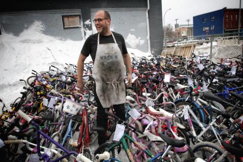Pat Krawec the Executive Director at The Wrench, a bicycle repair education and cycling hub, stands among the finished bikes during the Cycle of Giving at the Atomic Centre on Logan Avenue. Dozens of mechanics have been working for the last twenty-four hours fixing up over 200 bicycles for Winnipeg children in need in the second annual event.  121216 December 16, 2012 Mike Deal / Winnipeg Free Press
deal2012poy