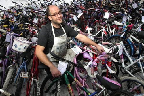 Pat Krawec the Executive Director at The Wrench, a bicycle repair education and cycling hub, stands among the finished bikes during the Cycle of Giving at the Atomic Centre on Logan Avenue. Dozens of mechanics have been working for the last twenty-four hours fixing up over 200 bicycles for Winnipeg children in need in the second annual event.  121216 December 16, 2012 Mike Deal / Winnipeg Free Press