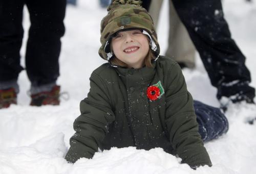 Caleb Gogela, 6, plays in the snow while waiting for members of the 38th Canadian Brigade Group to start a Remembrance Day gun salute at the Legislative Building, November 11, 2012. (TREVOR HAGAN/WINNIPEG FREE PRESS)