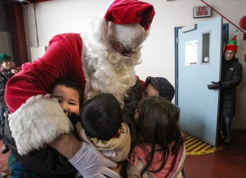 Santa (Doug Speirs) gets in lots of hugs from excited school kids as he arrives after a flight on the STARS helicopter. Around 150 kids from three Winnipeg School Division elementary schools, Strathcona, Mulvey and Dufferin, got to have lunch in the Winnipeg James Armstrong Richardson International Aiport's firehall where Santa just happened to be testing out the STARS helicopter. Fred Penner was on hand to perform some music too. 121217 - Monday, December 17, 2012 -  (MIKE DEAL / WINNIPEG FREE PRESS)
deal2012poy