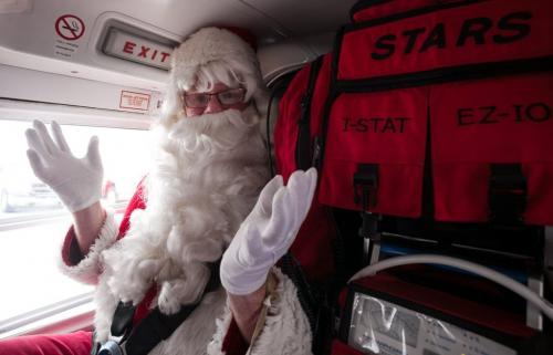 Santa Claus (Doug Speirs) just before take off in the STARS Air Ambulance for Santa's test flight Monday afternoon. The Winnipeg Airports Authority partnered with STARS to bring in 150 students to meet Santa after his test flight. (Melissa Tait / Winnipeg Free Press)