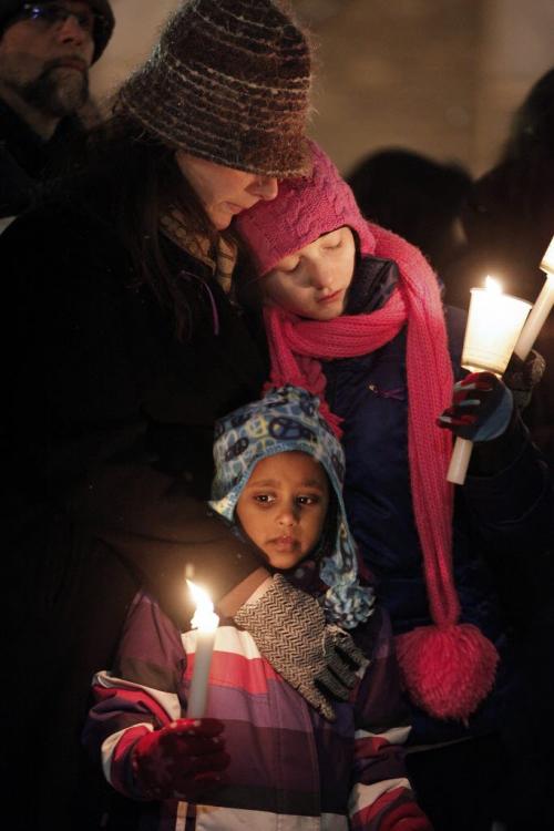 December 17, 2012 - 121217  -  On Monday December 17, 2012 at the University of Winnipeg a woman comforts children at a vigil for six year old Ana Grace Marguez-Greene who was killed in Newtown, CT Friday, December 14. Ana mother taught at the University of Winnipeg and her father taught at the University of Manitoba before moving to Newtown this past July John Woods / Winnipeg Free Press