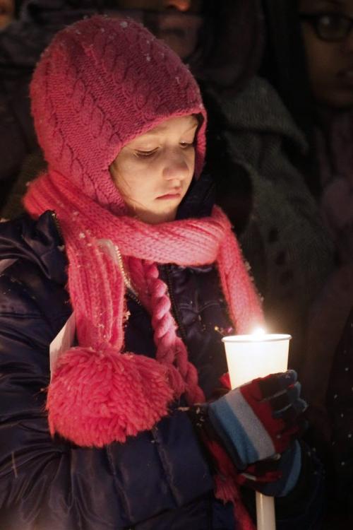 December 17, 2012 - 121217  -  On Monday December 17, 2012 a young girl contemplates during a moment of silence at a vigil at the University of Winnipeg for six year old Ana Grace Marguez-Greene who was killed in Newtown, CT Friday, December 14. Ana mother taught at the University of Winnipeg and her father taught at the University of Manitoba before moving to Newtown this past July John Woods / Winnipeg Free Press