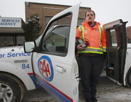 Matt Charriere, a CAA driver with a CAA Battery Service Vehicle similar to the one he was standing beside helping a customer when a vehicle passed by him so closed it  brushed against the smaller door at right. The vehicle was not damaged and Matt wasn't injured but it was a close call. Matt Bedard story.  (WAYNE GLOWACKI/WINNIPEG FREE PRESS) Winnipeg Free Press  Dec.18   2012
