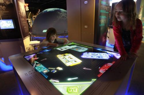 At right, Deanna Koster,5, and Peytyn Christensen-Turner,5, play on the touch table simulating preparing meals in spare. Part of the  Living in Space Exhibit at the Manitoba Museum. Ryan Bowman story  (WAYNE GLOWACKI/WINNIPEG FREE PRESS) Winnipeg Free Press  Dec.18   2012