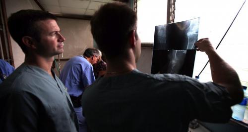 Surgeon Eric Bohm (left) checks x-rays.....during the patient assessment clinic in Managua.....SEE HIS QOUTES from the video Melissa did....they were good!!!