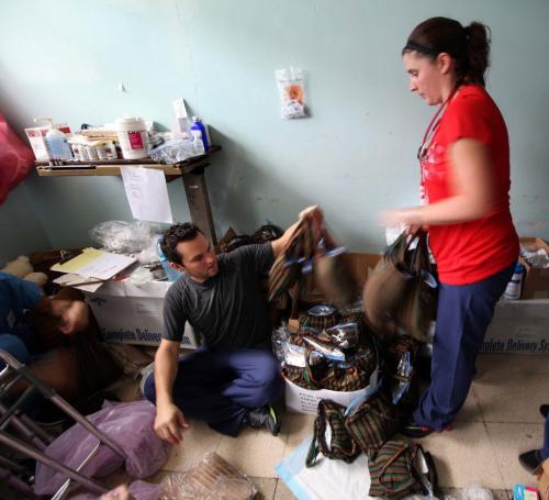 RN Lauren Young and her husband Cory work packing patient supplies on the recovery ward in Managua......
