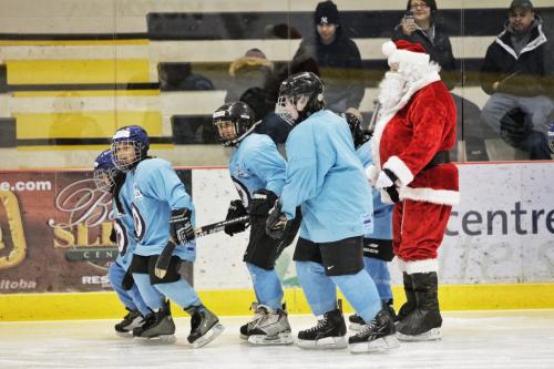 Santa is pulled by grade 4-5 kids from Stevenson Britannia school who are taking part in the Winnipeg Jets Hockey Academy program at the MTS IcePlex Thursday afternoon. Though Santa is keeping in shape by getting some ice time with the WJHA in the days leading up to Christmas next week he is always looking for extra help to pull his sleigh on the big nightÄ¶ you never know! 121220 December 20, 2012 Mike Deal / Winnipeg Free Press