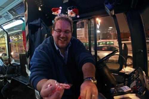 Since the world didn't end Friday, Winnipeg Transit driver David Cook was hard at work greeting riders on his bus and handing out candy canes in the holiday spirit.     (WAYNE GLOWACKI/WINNIPEG FREE PRESS) Winnipeg Free Press  Dec.21   2012