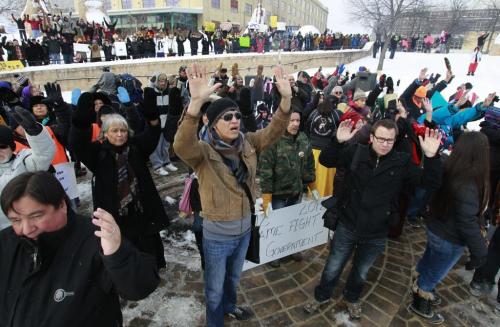 About 300 people attended a Idle No More rally in the Oodena Celebration Circle at The Forks Friday in solidarity with an Idle No More rally at Parliament Hill in Ottawa. In photo the people raised their hands in the four directions.     (WAYNE GLOWACKI/WINNIPEG FREE PRESS) Winnipeg Free Press  Dec.21   2012