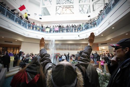 December 22, 2012 - 121222  - A woman raises her hands as hundreds of people take part in an Idle No More flash mob round dance at Portage Place Saturday, December 22, 2012. Idle No More is a national protest movement bringing attention to the impact of the federal government's omnibus budget bill and its provisions to ease protections against aboriginal land surrenders and environmental legislation for lakes and rivers. John Woods / Winnipeg Free Press