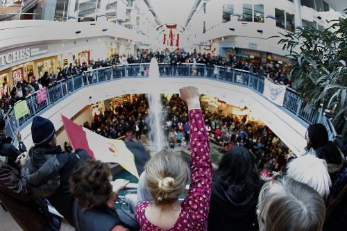 December 22, 2012 - 121222  - A woman raises her fist as hundreds of people take part in an Idle No More flash mob round dance at Portage Place Saturday, December 22, 2012. Idle No More is a national protest movement bringing attention to the impact of the federal government's omnibus budget bill and its provisions to ease protections against aboriginal land surrenders and environmental legislation for lakes and rivers. John Woods / Winnipeg Free Press