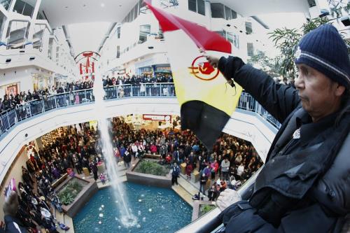 December 22, 2012 - 121222  - Percy Ballantyne waves an American Indian Movement flag as hundreds of people take part in an Idle No More flash mob round dance at Portage Place Saturday, December 22, 2012. Idle No More is a national protest movement bringing attention to the impact of the federal government's omnibus budget bill and its provisions to ease protections against aboriginal land surrenders and environmental legislation for lakes and rivers. John Woods / Winnipeg Free Press