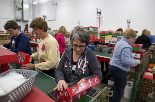 Mary Friesen (R) of Steinbach, Manitoba helps pack Christmas boxes at the Samaritan's Purse operation during the Christmas season in Calgary, Alberta, December 3, 2012. Operation Christmas Child was started in 1990. In 1993, Operation Christmas Child grew and was adopted by Samaritan's Purse, a Christian organization run by Franklin Graham. To date, Operation Christmas Child has collected and distributed over 94 million shoe box gifts worldwide.  Each shoe box gift is filled with hygiene items, school supplies, toys, and candy, is given to children regardless of gender, race, religion, or age. Photograph by Todd Korol for The Winnipeg Free Press