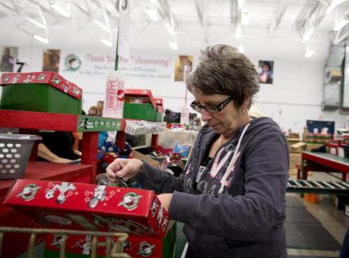 Mary Friesen of Steinbach, Manitoba helps pack Christmas boxes at the Samaritan's Purse operation during the Christmas season in Calgary, Alberta, December 3, 2012. Operation Christmas Child was started in 1990. In 1993, Operation Christmas Child grew and was adopted by Samaritan's Purse, a Christian organization run by Franklin Graham. To date, Operation Christmas Child has collected and distributed over 94 million shoe box gifts worldwide.  Each shoe box gift is filled with hygiene items, school supplies, toys, and candy, is given to children regardless of gender, race, religion, or age. Photograph by Todd Korol for The Winnipeg Free Press