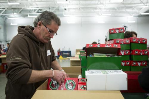 Henry Friesen of Steinbach, Manitoba helps pack boxes at the Samaritan's Purse operation during the Christmas season in Calgary, Alberta, December 3, 2012. In 1993, Operation Christmas Child grew and was adopted by Samaritan's Purse, a Christian organization run by Franklin Graham. To date, Operation Christmas Child has collected and distributed over 94 million shoe box gifts worldwide.  Each shoe box gift is filled with hygiene items, school supplies, toys, and candy, is given to children regardless of gender, race, religion, or age. Photograph by Todd Korol for The Winnipeg Free Press