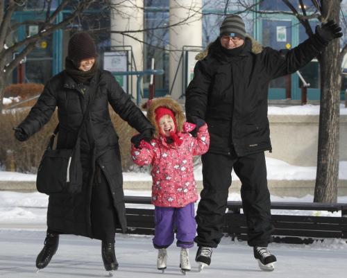 Judith Bowden and Jeff Cummings take their daughter Molly,5 for a skate at The Forks on this crisp Christmas Eve day. Intern Meagan Franklin story    (WAYNE GLOWACKI/WINNIPEG FREE PRESS) Winnipeg Free Press  Dec.24   2012