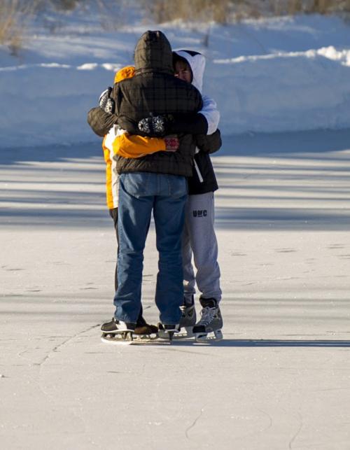 122512 Winnipeg -  Ice skaters embrace during the cold temperatures Tuesday afternoon on Christmas day at Assiniboine Park. DAVID LIPNOWSKI / WINNIPEG FREE PRESS