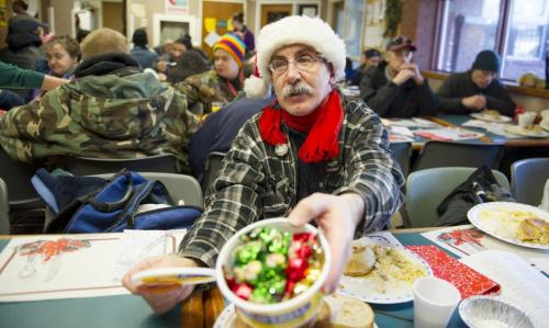 122512 Winnipeg -  Barry Kopulos hands out candies to new and old friends during the annual Christmas Day luncheon at the West Broadway Community Ministry Tuesday afternoon on Christmas day. The lunch was prepared and served mainly by members of Shaarey Zedek Synagogue. DAVID LIPNOWSKI / WINNIPEG FREE PRESS