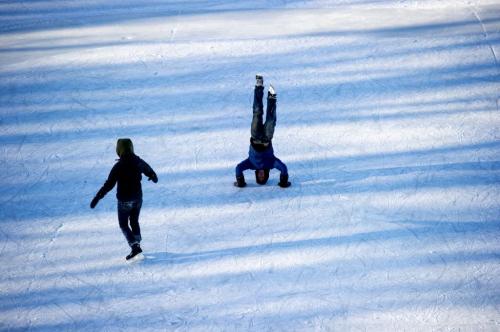122612 Winnipeg - Coral Maloney watches her friend Simon Hon do a handstand on the River Trail at The Forks Wednesday on Boxing Day.  DAVID LIPNOWSKI / WINNIPEG FREE PRESS
