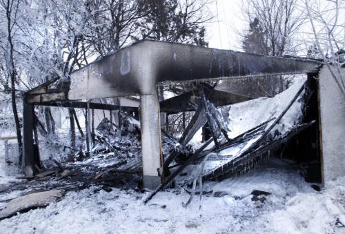 A double car garage behind a house in the 700 Block of Stella Ave. near Arlington St was destroyed in a early morning fire Thursday. (WAYNE GLOWACKI/WINNIPEG FREE PRESS) Winnipeg Free Press  Dec.27   2012