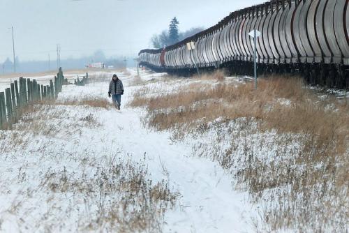 A man goes for a long walk Thursday along a endless lineup of railway grain cars along Highway 7 just north of Winnipeg- Standup Photo- December 27, 2012   (JOE BRYKSA / WINNIPEG FREE PRESS