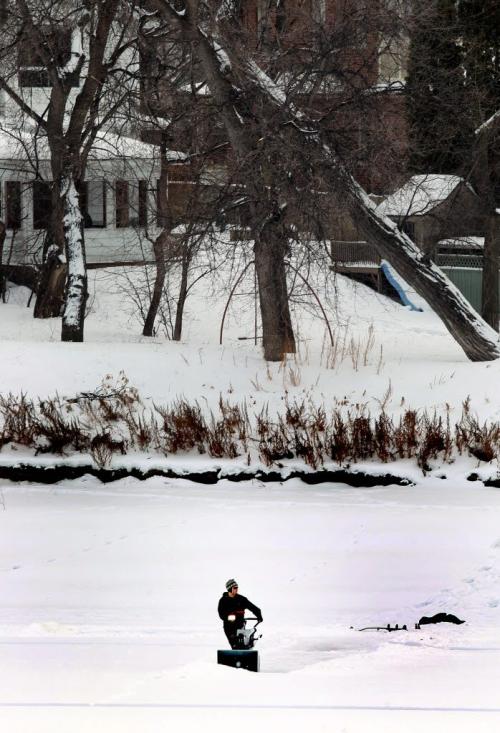 Let the games begon......seemingly undaunted by the sheer scale of the potential, a skating enthusiast begins the job of clearing a rink on the Red River just North of the Redwood Bridge THursday afternoon.......STAND UP December 27, 2012 - (Phil Hossack / Winnipeg Free Press)