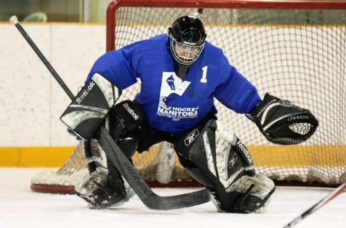 Christian Clavelle makes a glove save during a weekly game of hockey at the Winnipeg Winter Club, Saturday, December 29, 2012. (TREVOR HAGAN/ WINNIPEG FREE PRESS)