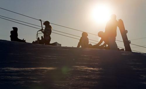 Skiers and snowboarders silhouetted by the afternoon sun at Springhill, located in the floodway, Saturday, December 29, 2012. (TREVOR HAGAN/WINNIPEG FREE PRESS)