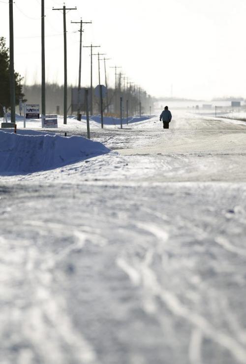 A pedestrian walks along highway 59 on a cold winter afternoon, Saturday, December 29, 2012. (TREVOR HAGAN/WINNIPEG FREE PRESS)
