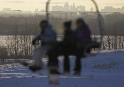 The Winnipeg skyline seen through chairlift carrying skiers and snowboarders at Springhill, located in the floodway, Saturday, December 29, 2012. (TREVOR HAGAN/WINNIPEG FREE PRESS)
