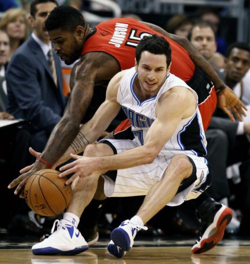 Orlando Magic guard J.J. Redick Hedo Turkoglu (front) is fouled by Toronto Raptors forward Amir Johnson during the first half of their NBA basketball game in Orlando, Florida December 29, 2012 REUTERS/Kevin Kolczynski (UNITED STATES - Tags: SPORT BASKETBALL)