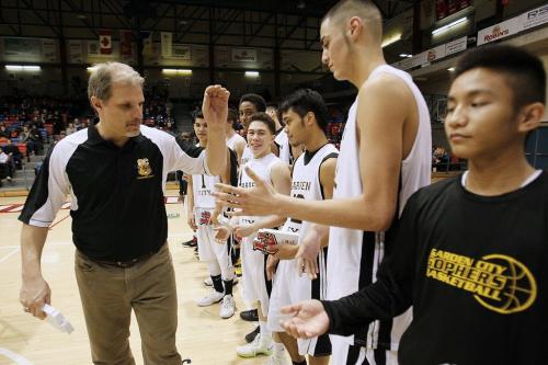 December 30, 2012 - 121230 - Garden City Fighting Gophers coach Phil Penner hi-fives his players after defeating the Oak Park Raiders in the high school final of the Wesmen Classic at the University of Winnipeg Sunday December 30, 2012. Garden City defeated Oak Park for their third straight championship. John Woods / Winnipeg Free Press