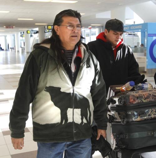 From left, Cross Lake First Nation elder Raymond Robinson and son Baptiste at the James A. Richardson International Airport to catch a flight to Ottawa Monday for Robinson to join Chief Spence of Attawapiskat in her hunger strike. Robinson has been on hunger strike with her since Dec 12.¤ ¤ ¤(WAYNE GLOWACKI/WINNIPEG Free Press) Dec. 31 2012