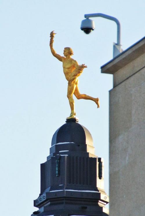 A security camera on the Great West Life building seems to keep watch over the Manitoba Legislative buildings Golden Boy as the sun rises early Tuesday morning on New Year's Day.  130101 January 01, 2013 Mike Deal / Winnipeg Free Press
