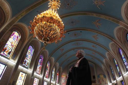 The Rt. Rev. Msgr. Mitrat Michael Buyachok with the new chandelier made in Greece especially for the Ukrainian Catholic Metropolitan Cathedral of Sts. Vladimir and Olga that was installed last week in time for the celebration of Ukrainian Christmas Eve Sunday Jan.6th. The 385 kg. chandelier is made of brass and is 24 carat gold plated and cost over $30,000 paid for by a  family donation. It took twelve men to install it.   see info   . (WAYNE GLOWACKI/WINNIPEG FREE PRESS) Winnipeg Free Press  Jan.3    2013