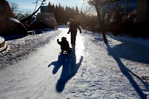 Winnipeger''s enjoyed  skating a sliding under sunny skies at The Forks  Saturday afternoon.  Dad pulls his kid on a sled next to Forks amptheatre. Standup photo. Jan 03, 2013, Ruth Bonneville  (Ruth Bonneville /  Winnipeg Free Press)