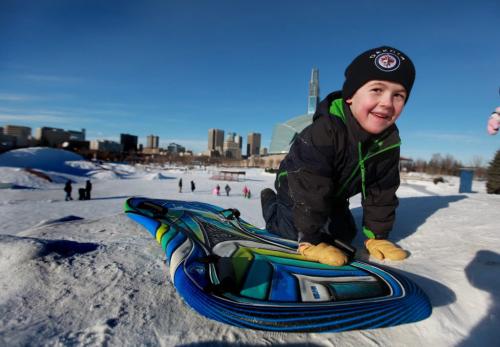 Five year old Tyler Free climbs the toboggan hill at the Forks Saturday afternoon while sliding with his sister Alana - 3yrs and parents.   Standup photo. Jan 03, 2013, Ruth Bonneville  (Ruth Bonneville /  Winnipeg Free Press)
