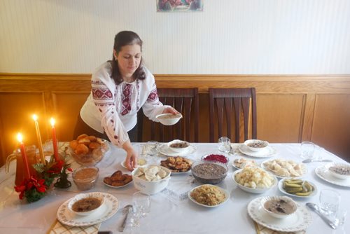 Brandon Sun 06012013 Nadiya Zaliska lays out food on the dinner table prior to Christmas Eve dinner at her family's home in Brandon on Sunday. For the many Ukrainians that follow the Julian calender today marks Christmas day. (Tim Smith/Brandon Sun)